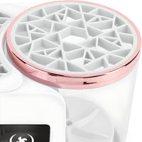 Close-up of electric cosmetic brush cleaner lid with geometric design and rose gold rim
