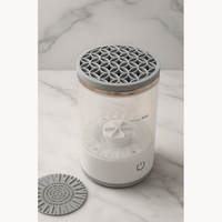 Electric makeup brush cleaner machine with detachable parts on marble background