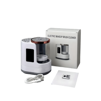 Electric makeup brush cleaner set with USB charging cable, instruction manual, and retail packaging box on a dark background.