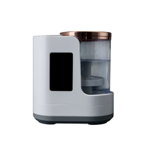 Close-up side view of an electric makeup brush cleaner with transparent water tank, rose gold lid, and modern smart design on a dark background.